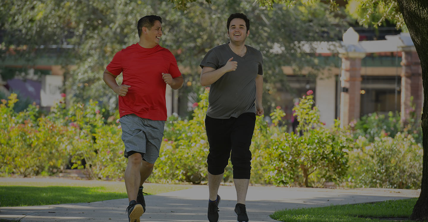 Two men jogging outside to promote a healthy lifestyle