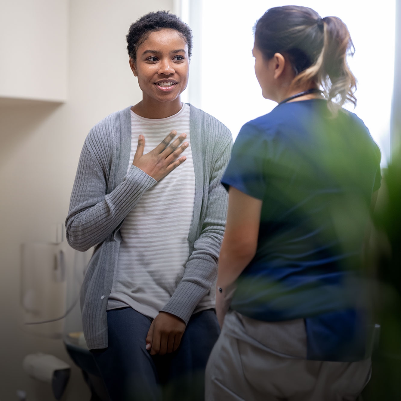 A woman talking to a nurse.