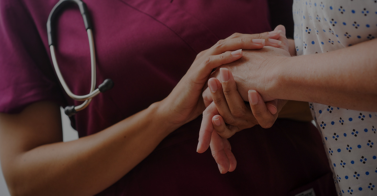 A nurse holding the hands of a diabetic patient to provide comfort and support