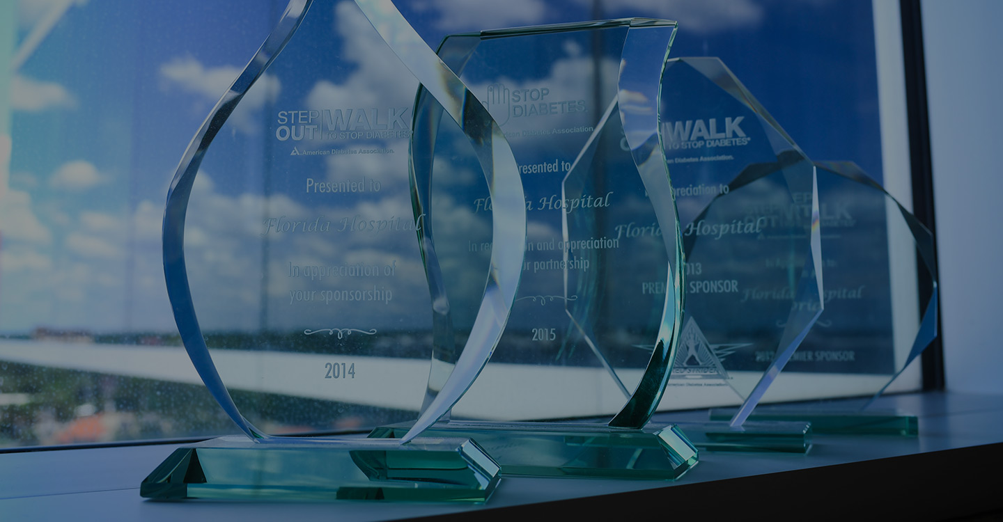 Four glass trophies awarding the AdventHealth Diabetes Institute for their outstanding work