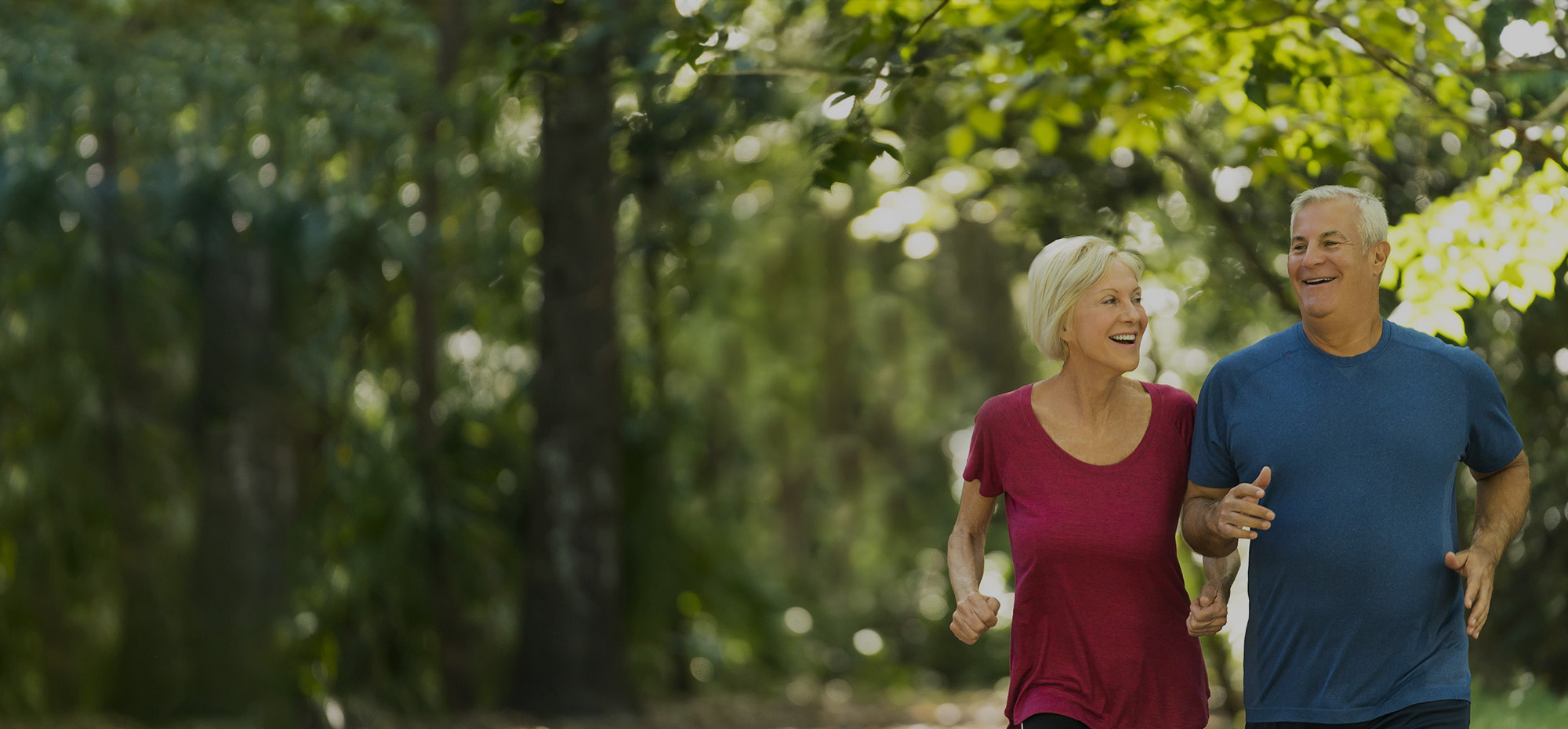 Man and Woman jogging in park.
